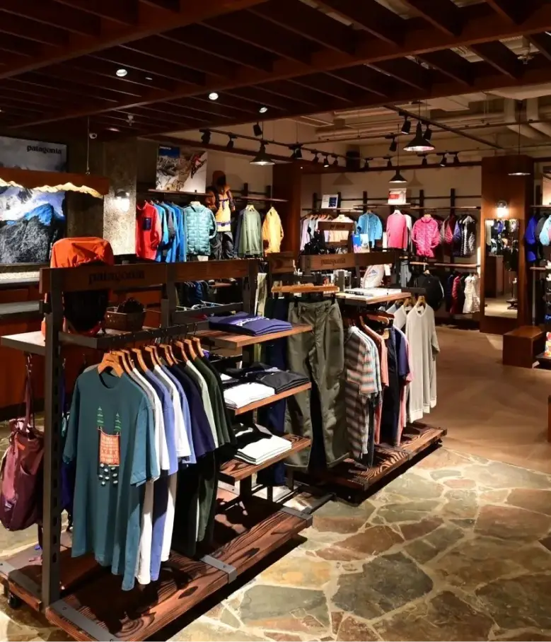 Interior of a Patagonia retail store featuring outdoor apparel on wooden display racks
