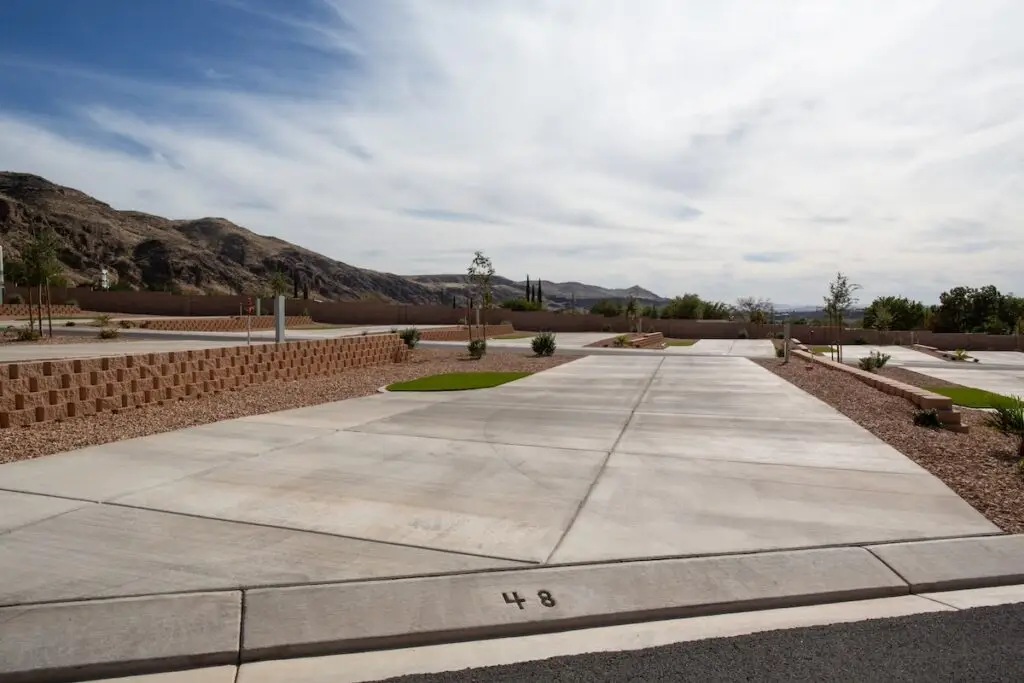 RV park in St. George, Utah, with spacious concrete sites, landscaped grounds, desert mountains, and scenic views near Zion National Park
