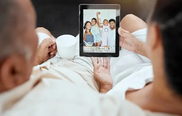 Senior couple video chatting with their family on a digital tablet