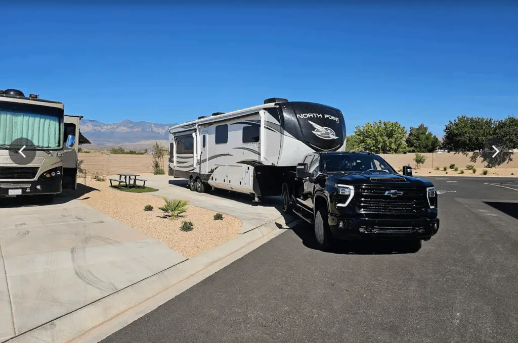 Pickup truck towing a fifth-wheel RV at a campground, representing RV resorts in Park City Utah for different travel styles