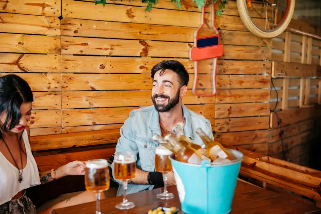 Friends enjoying craft beer and drinks at a rustic restaurant near Zion National Park, creating a relaxed dining experience after a day of exploring